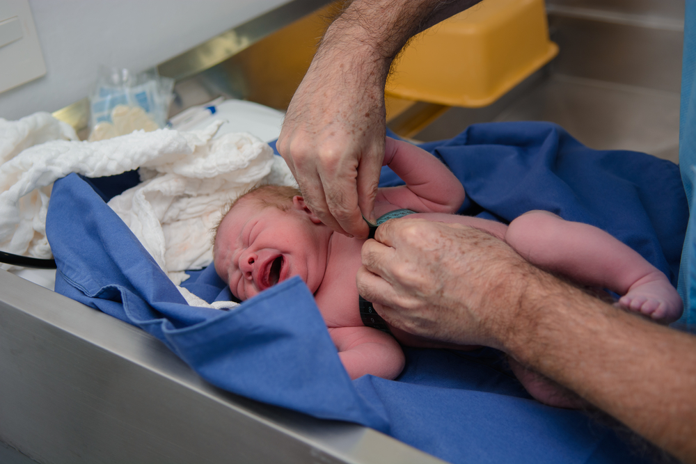 Photo of baby being measured