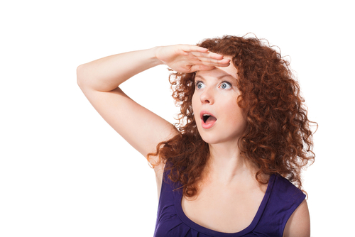 Attractive wondering woman looking at something far away