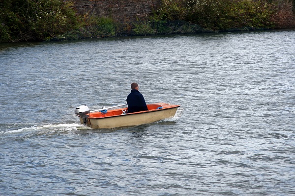 Teen boy using a small boat]