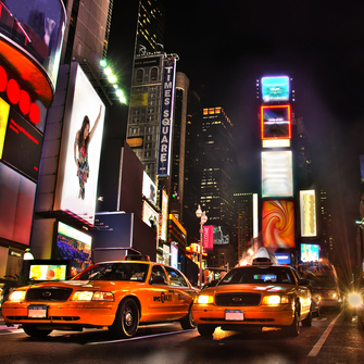 Times Square New York at night showing lighted billboards