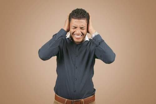 Man covering his ears.