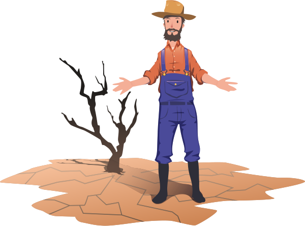 A farmer standing next to a dried dead tree.