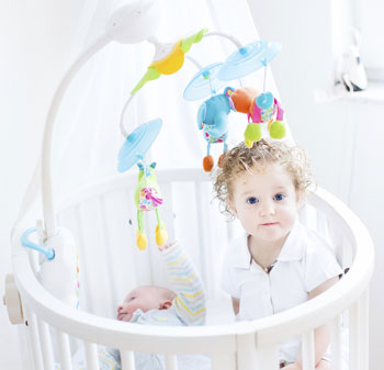 crib with a mobile over it
