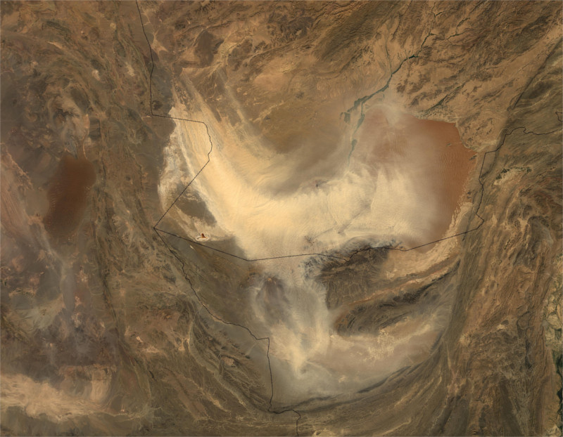 A satellite photograph captures a sandstorm ravaging the rugged desert region of Afghanistan.