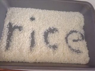 Word spelled in rice pan