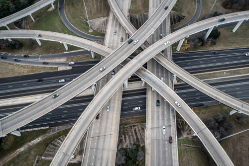 Aerial drone view highway interchange transportation roads new technology and growing fast past lifestyles and high speed traveling