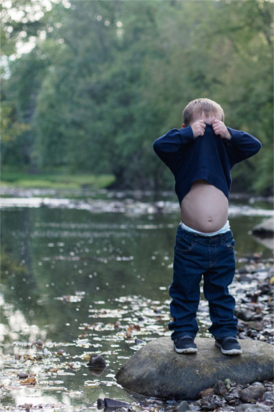 Child cover his face with shirt