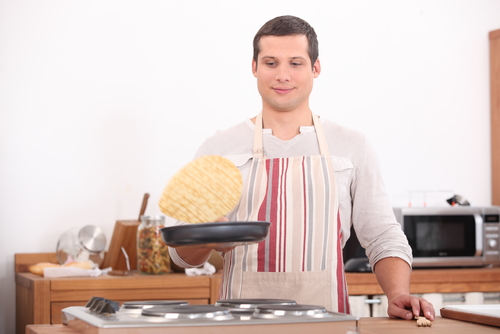 Man flipping a pancake.