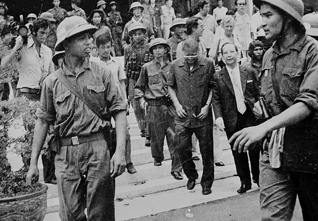 Dương Văn Minh, the last president of Vietnam is escorted away by PAVN soldiers.