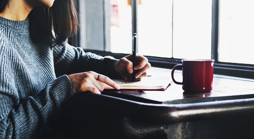 A girl writing in a notebook.