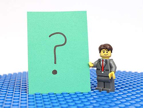 Studio shot of Lego minifigure with question mark Sign.