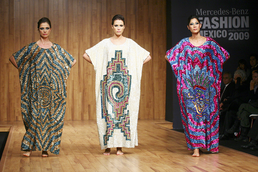 Models walk the runway wearing popular spanish colors.