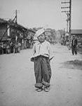 A Korean orphan boy adopted by a motor pool battalion at Inchon, Korea