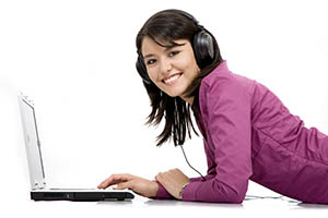student listening to music on laptop