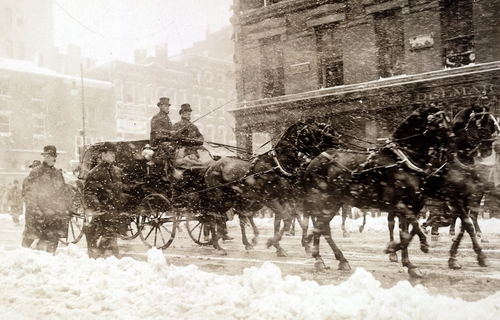 Horse drawn carriage carrying incoming President Taft, and Presiednt Theodore Roosevelt as they drive to the Capitol through the snow on March 4, 1909.