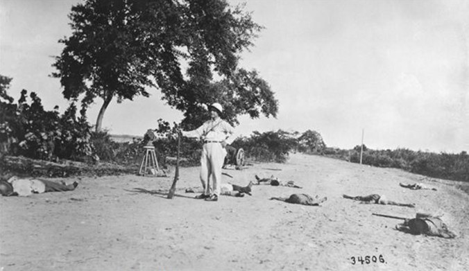 American poses with dead Haitian revolutionaries