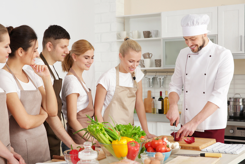 Teen boys and girls in a cooking class.