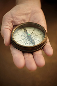 hand holding compass