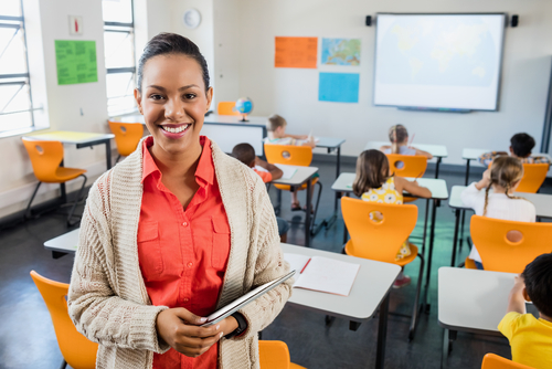 Teacher posing with her tablet at school
