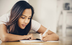 young woman writing in notebook
