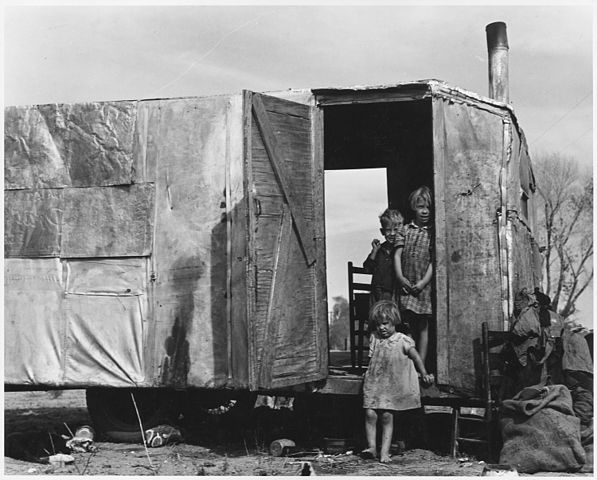 A migratory family living in a trailer in an open field. No sanitation, no water.