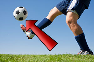 Man kicking soccer ball