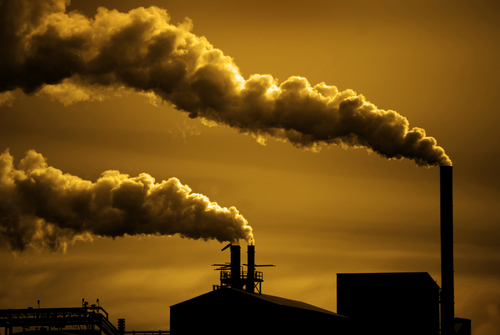 Pollution and smoke from chimneys of factory or power plant.