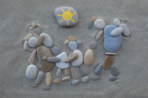 Escape from Syria, conceptual stones art over beach sand