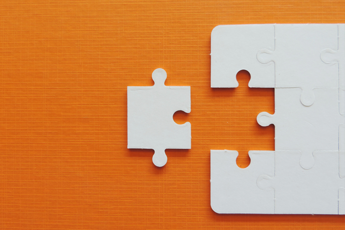 Puzzle jigsaw on orange background.