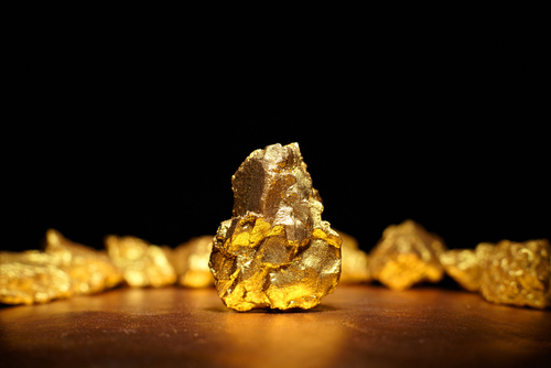 Closeup of big gold nugget finance concept.