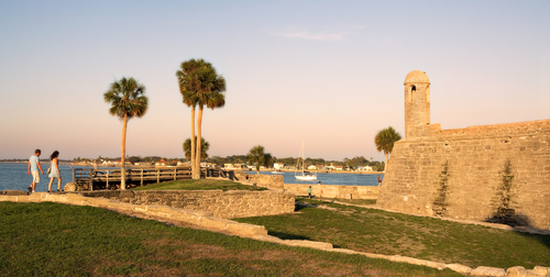 Tourists walk the walls of Castillo De San Marco, the oldest fort in the United States, in St Augustine Florida at sunset