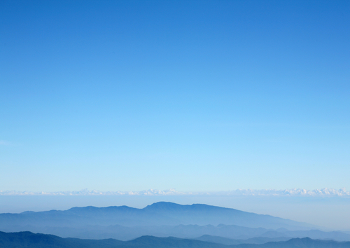 A mountain range with a smooth sky gradient