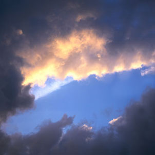 View of an overcast sky with blue sky poking through