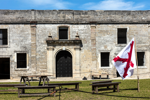 A view of Castillo de San Marcos and the Spanish Cross of Burgundy Flag in St Augustine, Florida. It is the oldest masonry fort in the continental United States, completed in 1695.