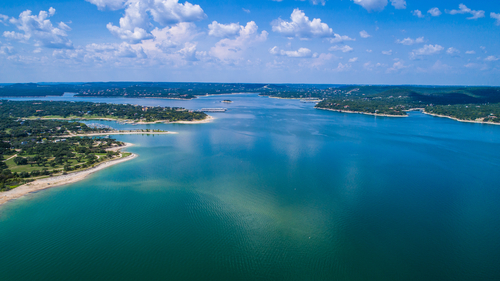 Reflections on the water Lake Travis a paradise of clear blue water and relaxation right outside Austin Texas an amazing summer landscape on the lake aerial drone view high above lake.