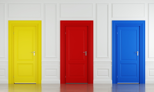 Three doors against a white wall: one's red, one's blue and one is yellow.