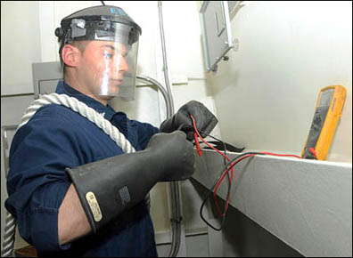 Rubber gloves and head gear protection for Navy electrician
