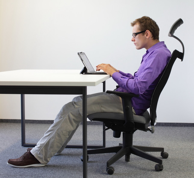 man sitting at desk typing on keyboard on a tablet