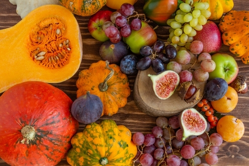 Autumn composition, Thanksgiving or Halloween concept, a lot of food, fruits, pumpkins, harvest. Flat lay, top view.