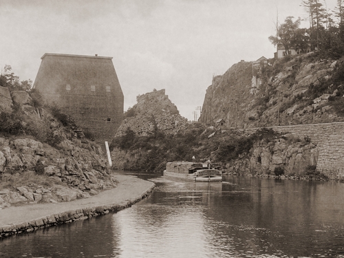 A barge passes through the Erie Canal at Little Falls, New York, circa 1890. Photo by William Henry Jackson.