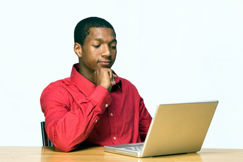 young man looking at his laptop