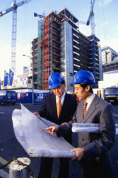 two architects looking at a blueprint
