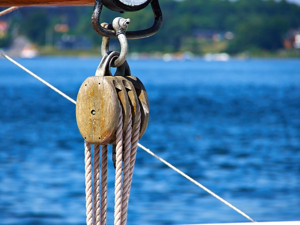 Pulley for sails and ropes made from wood on an old sail boat