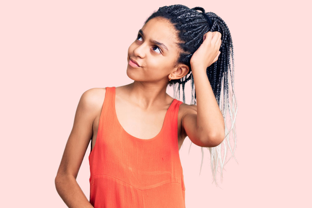 Girl thinking on pink background.
