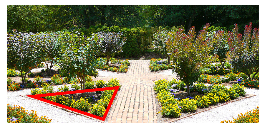Triangle-shaped garden bed with red border around the edges.