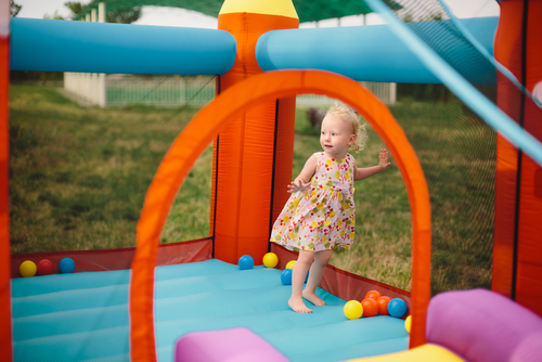 Little girl playing on trampoline