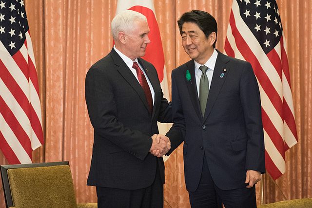 Shinzo Abe and Mike Pence shake hands