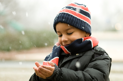 child holding snowflakes in hands