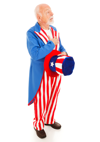 Uncle Sam standing at attention to recite the pledge of allegiance. Full body isolated.