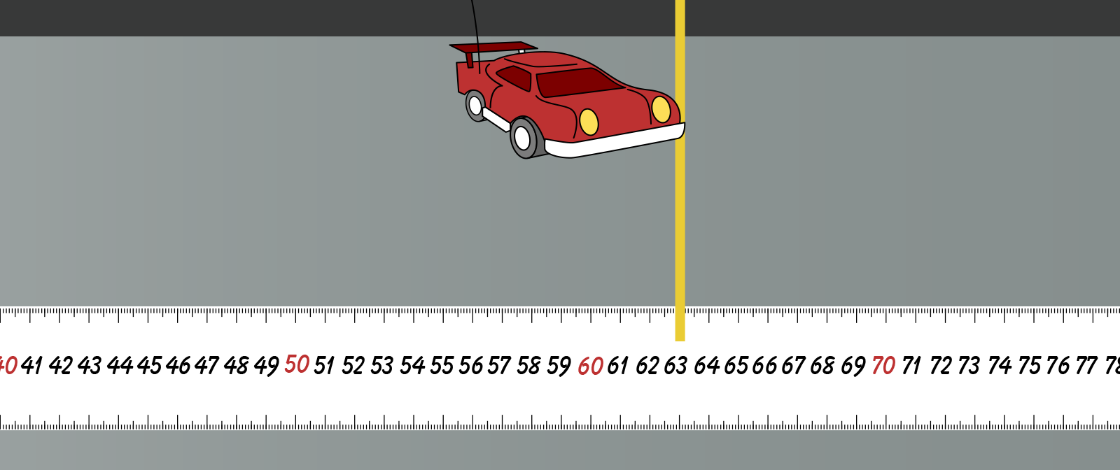 red remote control car on sidewalk with a meter stick laid down and 63 centimeters labeled